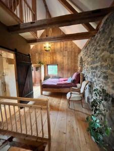 a bedroom with a bed and a stone wall at Urlaub in der Burg am Bodensee in Kressbronn am Bodensee