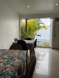 a room with a table and chairs with a view of the ocean at Killamoon House Paracas in Paracas +36 photos