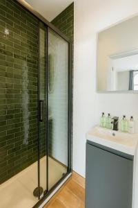 a bathroom with a shower and a sink at Stylish central apartment for 2 people free parking in Cardiff