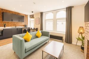 a living room with a couch and a kitchen at Stylish central apartment for 2 people free parking in Cardiff
