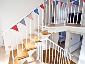 a staircase with colorful flags on the stairs at Sea Salt Lodge in Torquay