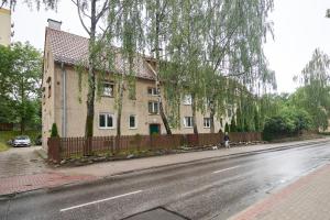 a person riding a bike in front of a house at GM Jagiellończyk in Olsztyn +8 photos