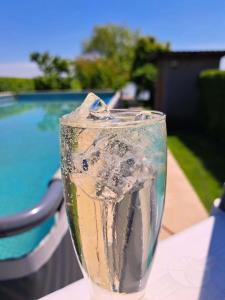 a glass vase sitting on a table next to a pool at Spinning la Divici in Divici