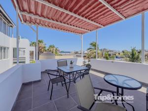 a view from the balcony of a villa with a table and chairs at Sea View Terrace 1BR Apartment 1 Block to Malecón in La Paz