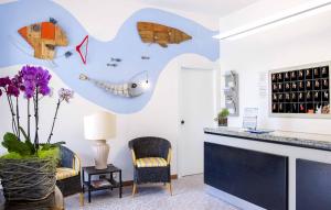 a room with a counter with a fish on the wall at Hotel Anfora in Castiglione della Pescaia