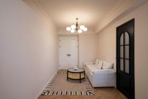 a living room with a white couch and a table at ZHome-FuDi Garden-Near the Bund in Shanghai +29 photos