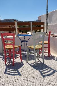 two chairs and a table and two chairs on a patio at Pappoudiko Myrto's Residence in Ágios Geórgios Sykoúsis