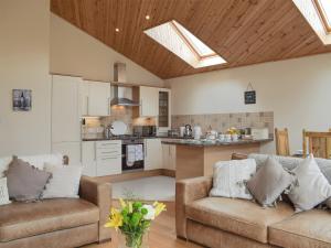a living room with two couches and a kitchen at Frith View in White Bridge