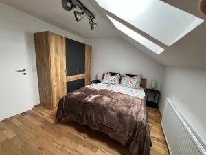 a bedroom with a bed and a skylight at Cityapartments Reutte-Mühl in Reutte