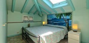 a bedroom with a bed in a room with a window at Terrazza sul Mare in Lido di Camaiore