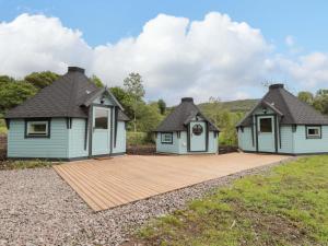 two houses with a wooden deck in a field at Little Luxe Lodges 2 in Coillemore