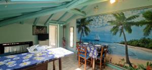 a dining room with a table and a painting on the wall at Terrazza sul Mare in Lido di Camaiore