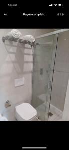 a bathroom with a toilet and a glass shower at Dany's Home Venus in Giovinazzo