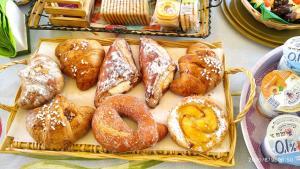 a tray of different types of pastries on a table at La Castellese in Aci Castello