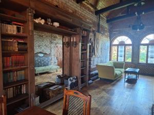 a living room with a couch and book shelves at Rent in summer in Ragaciems