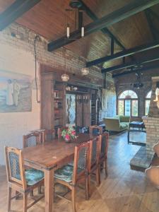 a dining room with a wooden table and chairs at Rent in summer in Ragaciems