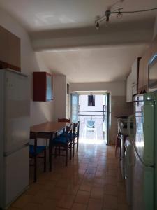 a kitchen with a table and chairs and a dining room at Appartamento completo o Camere private, Lecco Centro vicino alla stazione e al lago in Lecco