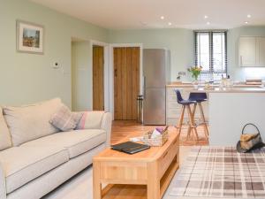 a living room with a couch and a table at Addycombe Cottage in Rothbury