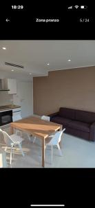 a living room with a table and chairs and a couch at Dany's Home Venus in Giovinazzo