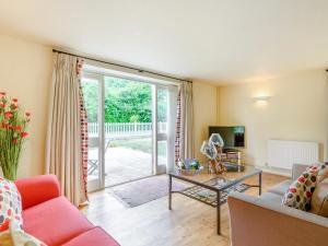 a living room with a couch and a table at Coach House - Uk33307 in Mellis