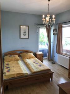 a bedroom with a bed and a chandelier at Holiday home in Balatonalmadi 38980 in Balatonalmádi