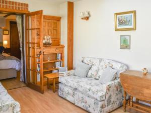 a living room with a couch and a table at The Old Workshop in Great Yarmouth +10 photos