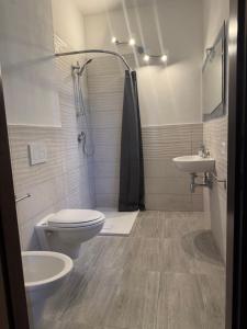 a bathroom with a toilet and a sink and a shower at Residence Villa Eva in Marina di Massa +23 photos