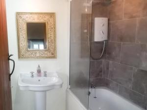 a bathroom with a sink and a toilet and a shower at Cragg Cottage in Bouth