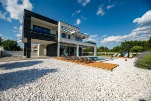 a large house with a swimming pool in front of it at Contemporary Zadar Villa 4 Bedrooms Villa Barako Prestige in Nin