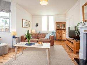 a living room with a couch and a table at The Old Toll House in Teignmouth