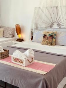 a bed with a box of towels on it at Errika's Sweet Home in Provatas