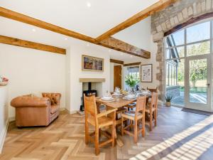 a dining room with a table and chairs at Badger Hill Barn in Malham