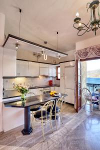 a kitchen with a table and chairs and a dining room at Infinity view in Sitia +19 photos
