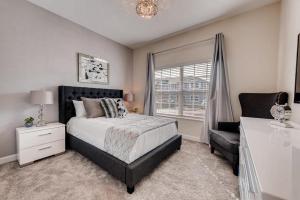 a bedroom with a bed and a chair and a window at 4825 LL - Storey Lake in Kissimmee