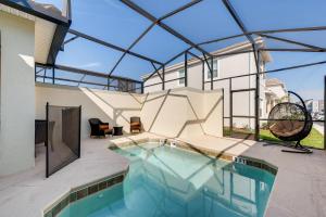 an indoor swimming pool in a house with glass ceilings at 4825 LL - Storey Lake in Kissimmee