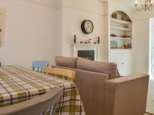a living room with a couch and a table at Sunnyside in West Mersea