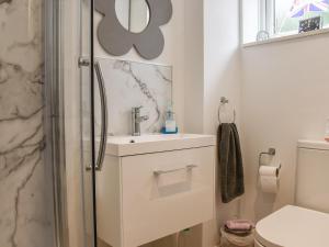 a bathroom with a sink and a toilet at Sunnyside in West Mersea +12 photos