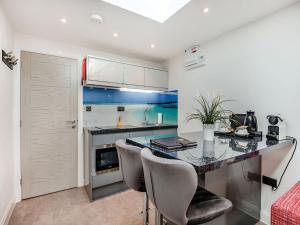 a kitchen with a table and chairs in a room at Little Heron - Uk40928 in Holdenhurst