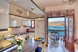 a kitchen with a large door leading to a balcony at Infinity view in Sitia