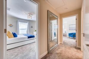 a bedroom with a bed and a mirror at 4825 LL - Storey Lake in Kissimmee