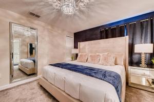 a bedroom with a large bed and a mirror at 4825 LL - Storey Lake in Kissimmee +42 photos