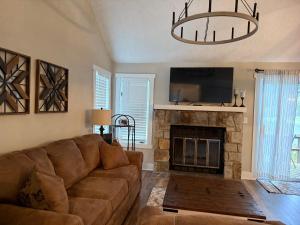 a living room with a couch and a fireplace at Hope's Hideaway in Blakeslee