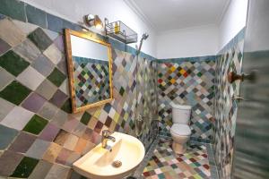 a bathroom with a sink and a toilet at Riad Zara Fez in Fès