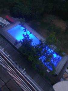 an overhead view of a building with blue lights at Doppelzimmer mit neuem Bad und Sportpool-Nutzung außen, im basement cellar der Villa Naturpark, Garten mit Rheinblick in Koblenz