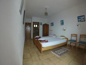A bed or beds in a room at Aphrodite Hotel