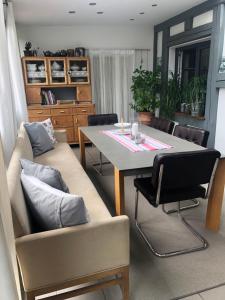 a living room with a couch and a table at Ferienwohnung Sonnentau 2 in Holzminden