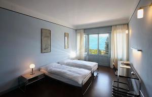 Ein Bett oder Betten in einem Zimmer der Unterkunft Hotel Monte Verità