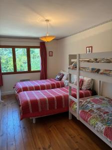 a bedroom with two beds and a bunk bed at Vacation home with pool in Quillan