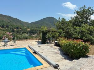 a swimming pool in a yard with mountains in the background at Vacation home with pool in Quillan
