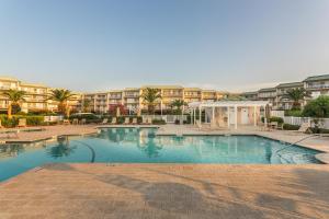 a large swimming pool in front of a hotel at St. Simons Grand #120 in Saint Simons Island